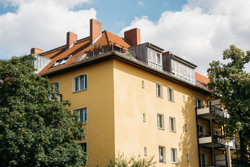 Fototapeta na wymiar yellow apartment building with chimneys