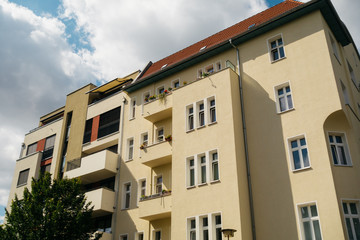 Fototapeta na wymiar old and modern yellow apartment house