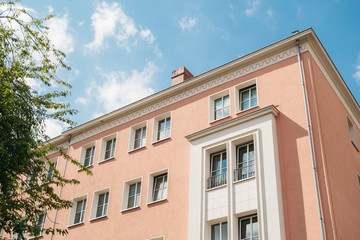 detailed view of apartment house with rose colored facade