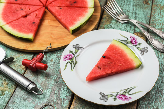 Watermelon cut like pizza with tire-bouchon and pizza knife. Low calorie healthy vegan refreshment
