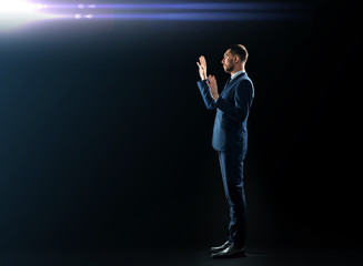 Fototapeta premium businessman in suit touching something invisible