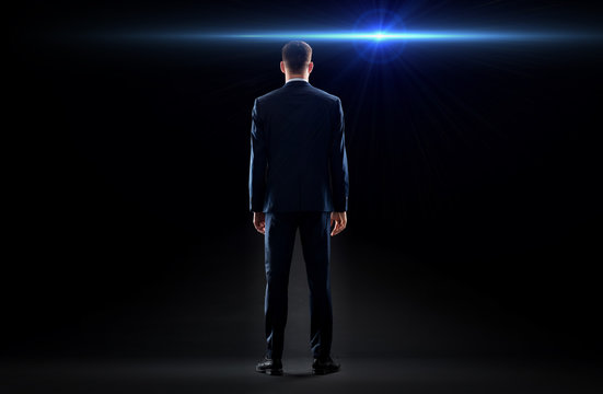 businessman in suit from back with laser light