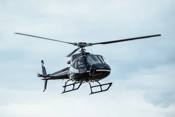 Fotobehang Black tourist helicopter flying © artmois
