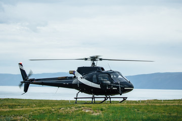 Black tourist helicopter rises in the air