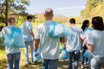 group of volunteers with garbage bags in park