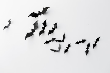 black paper bats over white background - obrazy, fototapety, plakaty