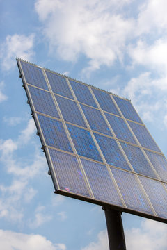 Pole with solar panels on a slowde sky.