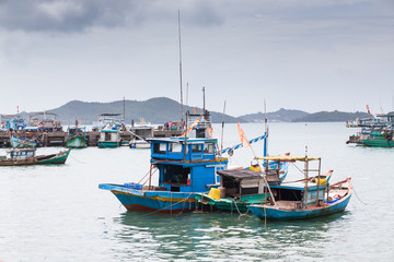 Naklejka na ściany i meble traditional colorful Vietnamese fishing boats in Ben Ngu wharf of Nam Du Islands, Kien Giang, Vietnam. Nam Du has become a popular tourist attraction, but foreigner are only allowed in with a permit.
