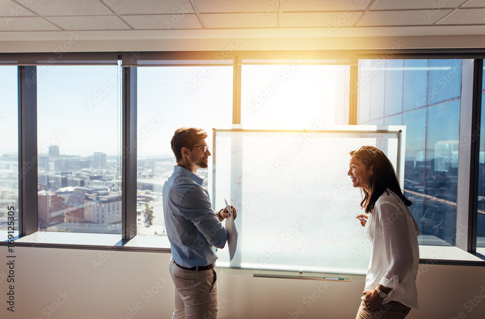 Wall mural Entrepreneurs discussing business ideas  in office.