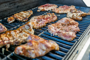  Delicious pork steaks on the grill 
