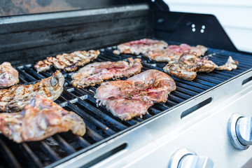  Delicious pork steaks on the grill 
