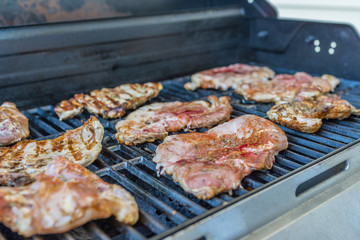  Delicious pork steaks on the grill 
