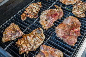  Delicious pork steaks on the grill 
