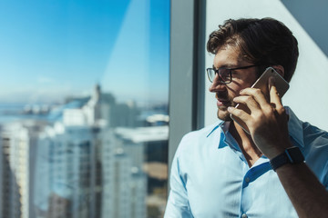 Closeup of a business investor talking on phone.