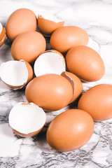 Egg shells in egg box. Close-up view of raw chicken eggs on grey background