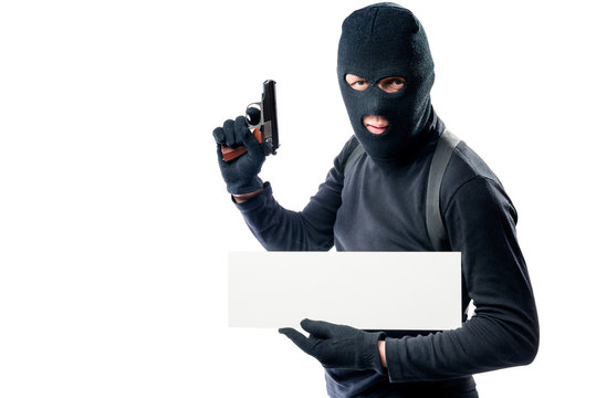 Portrait of an armed man in black clothes with a poster on a white background