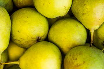 Green pears in a wicker basket