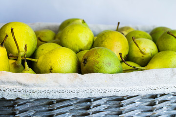 Green pears in a wicker basket