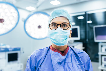 Fototapeta na wymiar Female surgeon wearing surgical mask and scrubs