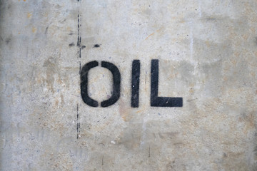 Text "OIL" by spraying on the cement wall.