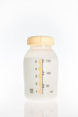 Milk breast pump in plastic bottle.