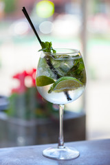 Glass tank mojito at the bar closeup. refreshing drink with Fresh mint, limes, sugar