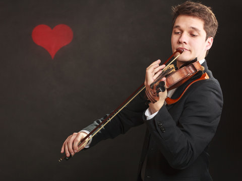 Man man dressed elegantly playing violin