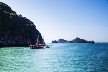 Obraz na płótnie Canvas boats among beautiful limestone rocks of Lan Ha bay, the twin of Ha Long bay ona sunny day, Vietnam