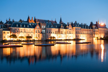Binnenhof Dutch Parliament next to Hofvijver lake at dusk during the blue hour. Binnenhof palace in Hague (Den Haag), Holland, Netherlands