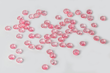 Pink acrylic beads on a white background