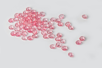 Pink acrylic beads on a white background