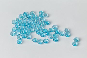 blue acrylic beads on a white background