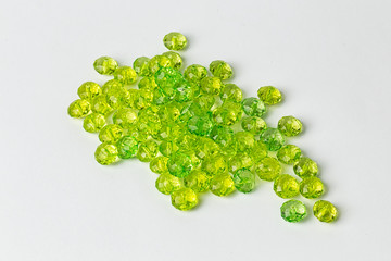 green acrylic beads on a white background