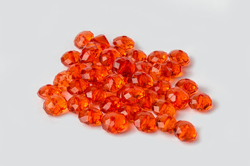 red acrylic beads on a white background