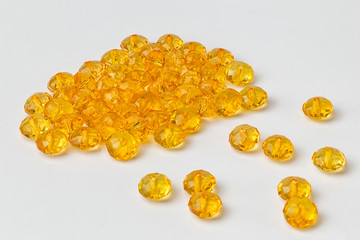 Yellow acrylic beads on a white background