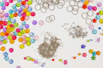 Set for design of colored beads on a white background, rings, beads, for example
