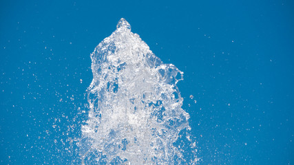 Splashes of fountain water at the top of stream eruption