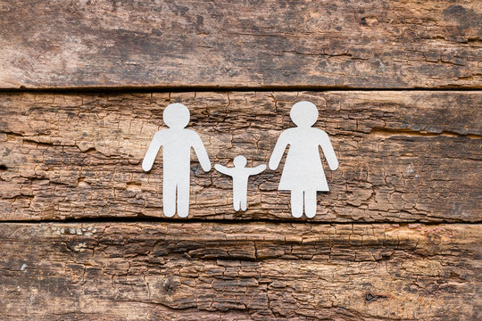 Paper family on a wooden background