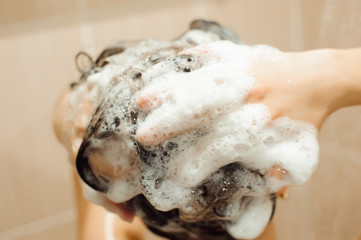 Beautiful naked young woman taking shower in bathroom