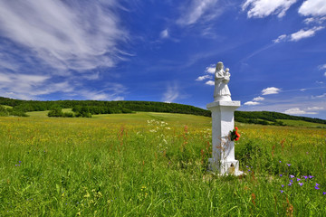 Small stone figure in rural landscape  of Beskid Niski, Zdynia, Poland - obrazy, fototapety, plakaty