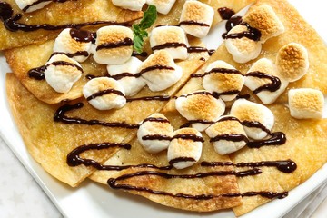 Dessert Nachos with Toasted Marshmallows drizzled with chocolate sauce