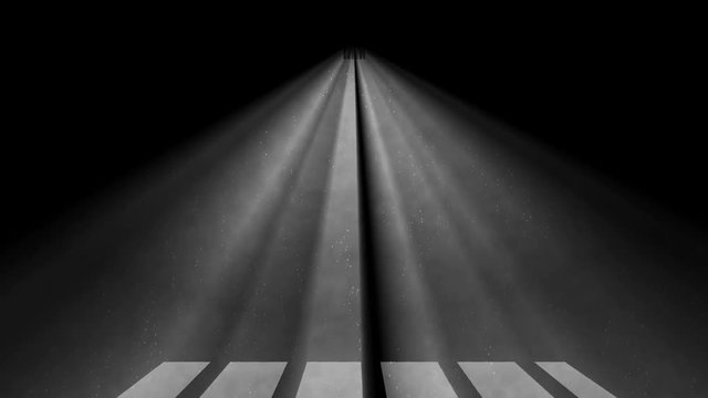 Light coming through a barred window with fog and shodow on a floor.