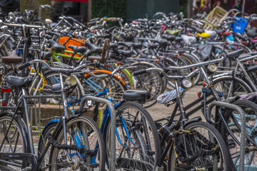 Fototapeta na wymiar Lots of bikes in the city of Amsterdam - AMSTERDAM - THE NETHERLANDS - JULY 20, 2017