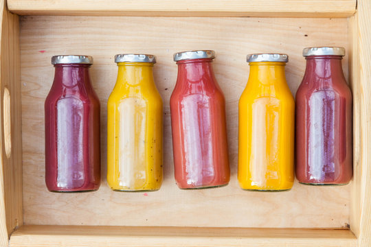 Blend Or Crushed Fruit Juice Or Smoothie In Wooden Box On Old Rustic Wooden Table, Top View, Selective Focus. Detox, Dieting, Clean Eating, Vegetarian, Vegan, Fitness, Healthy Lifestyle Concept