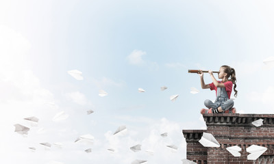 Concept of careless happy childhood with girl exploring this wor