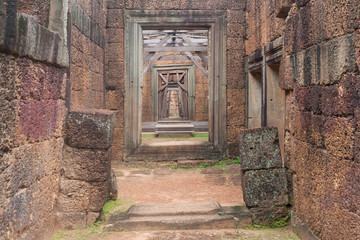 Corridor of Stone Walls and pillars to a Wood Door in Siem Reap Angkor Wat Temple Cambodia Asia