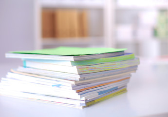 close up of stack of papers on white background