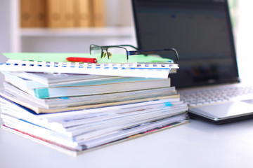 close up of stack of papers on white background