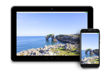 Tablet and phone with photographs of maritime landscapes on white background.