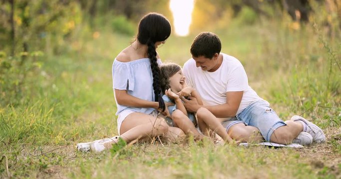 Mom And Dad Tickling Baby. Slow Motion